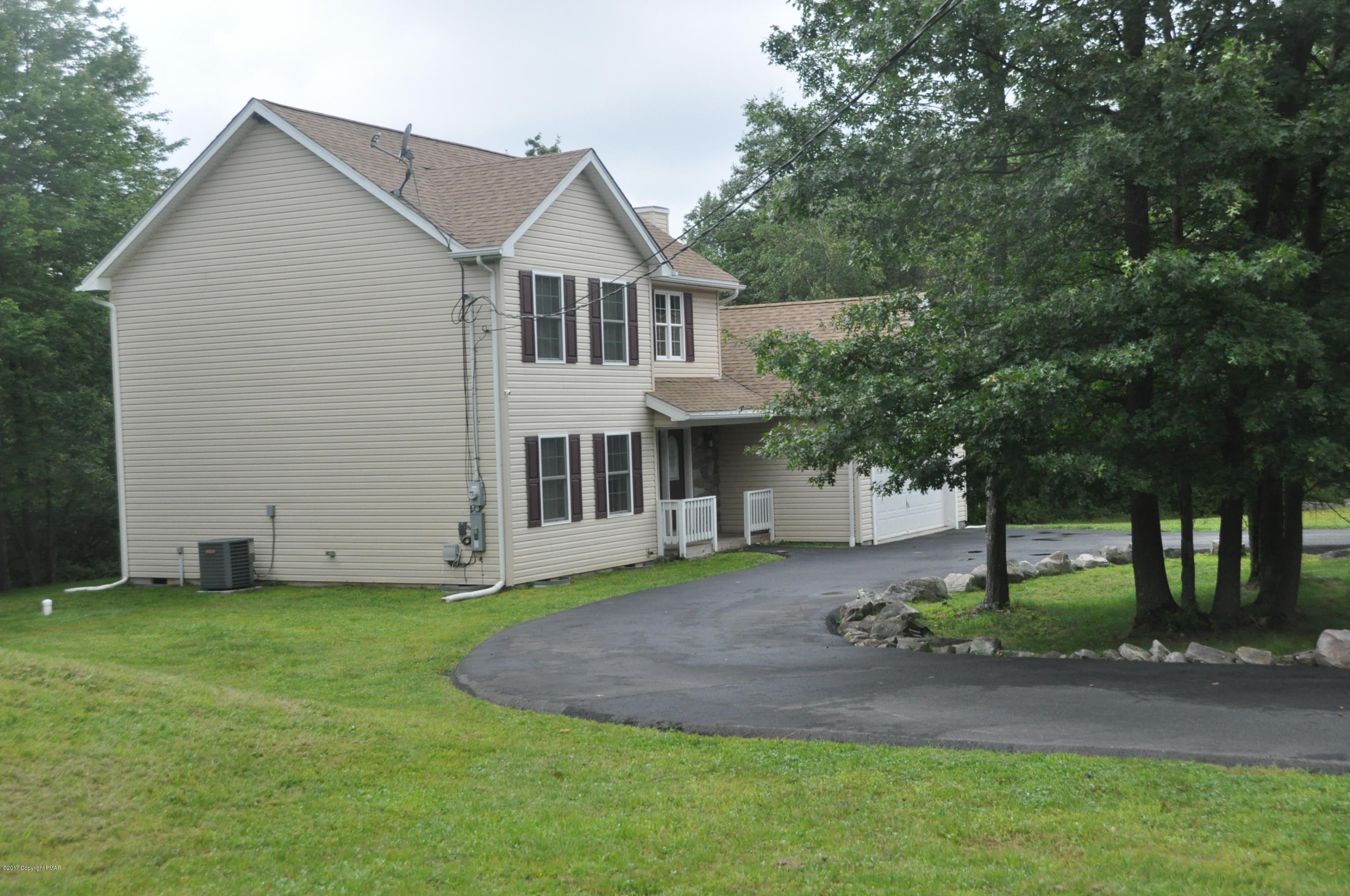 167 Sawmill Road Long Pond, PA 18334 - Photo 38 of 38 a front view of a house with a yard and garage