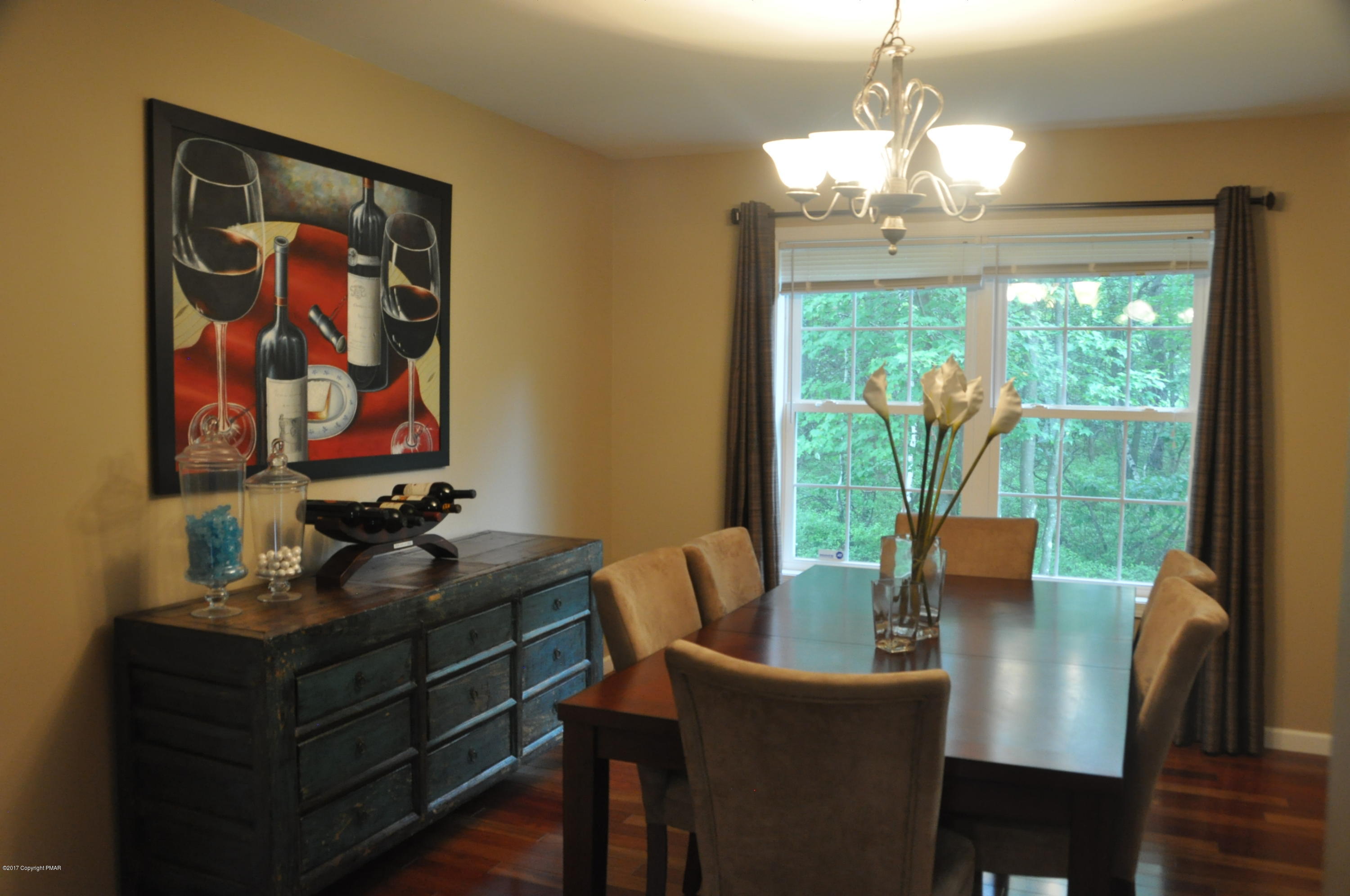 167 Sawmill Road Long Pond, PA 18334 - Photo 8 of 38 a dining room with furniture a large window and wooden floor