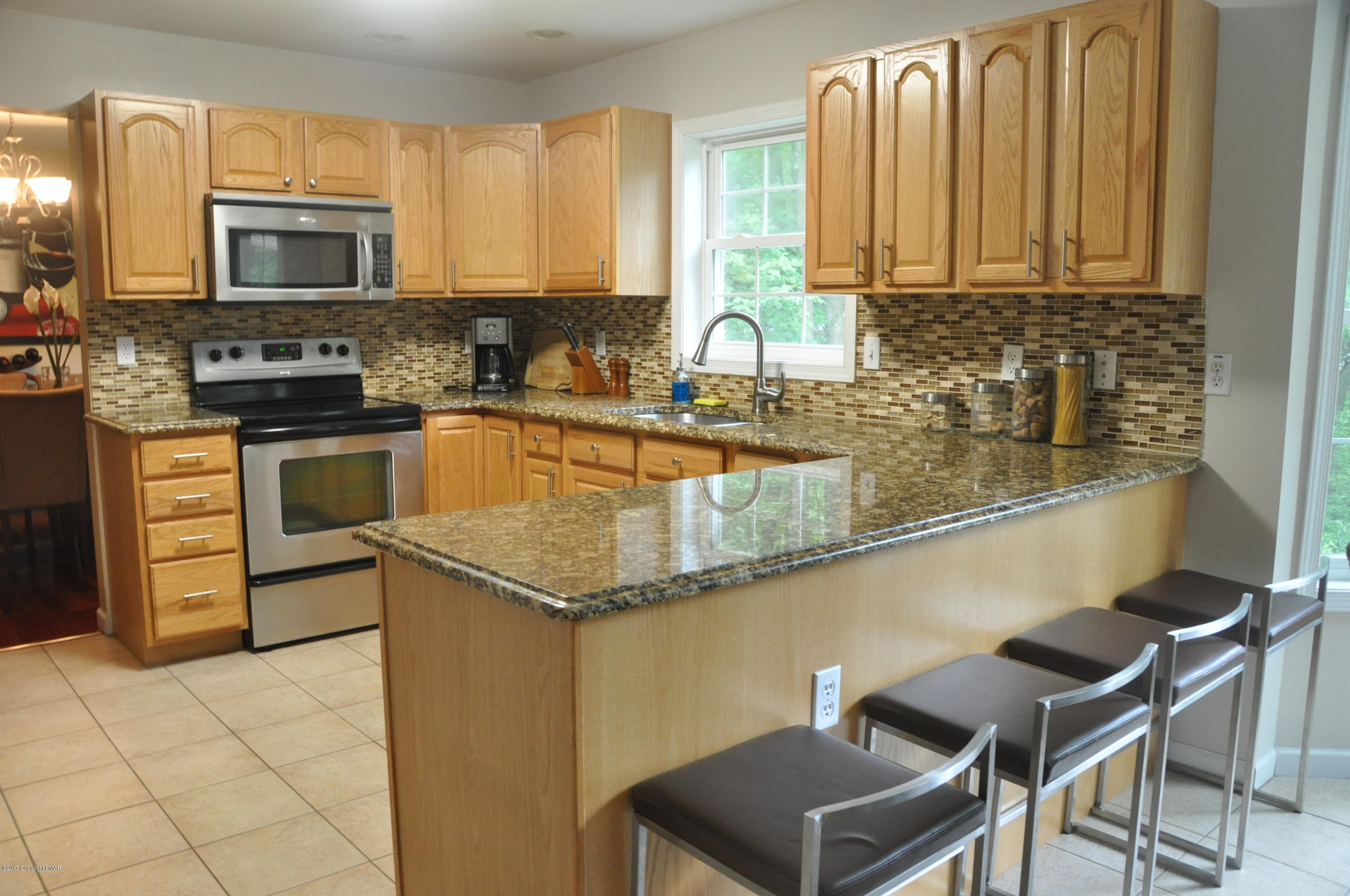 167 Sawmill Road Long Pond, PA 18334 - Photo 9 of 38 a kitchen with stainless steel appliances granite countertop a stove a sink and a microwave