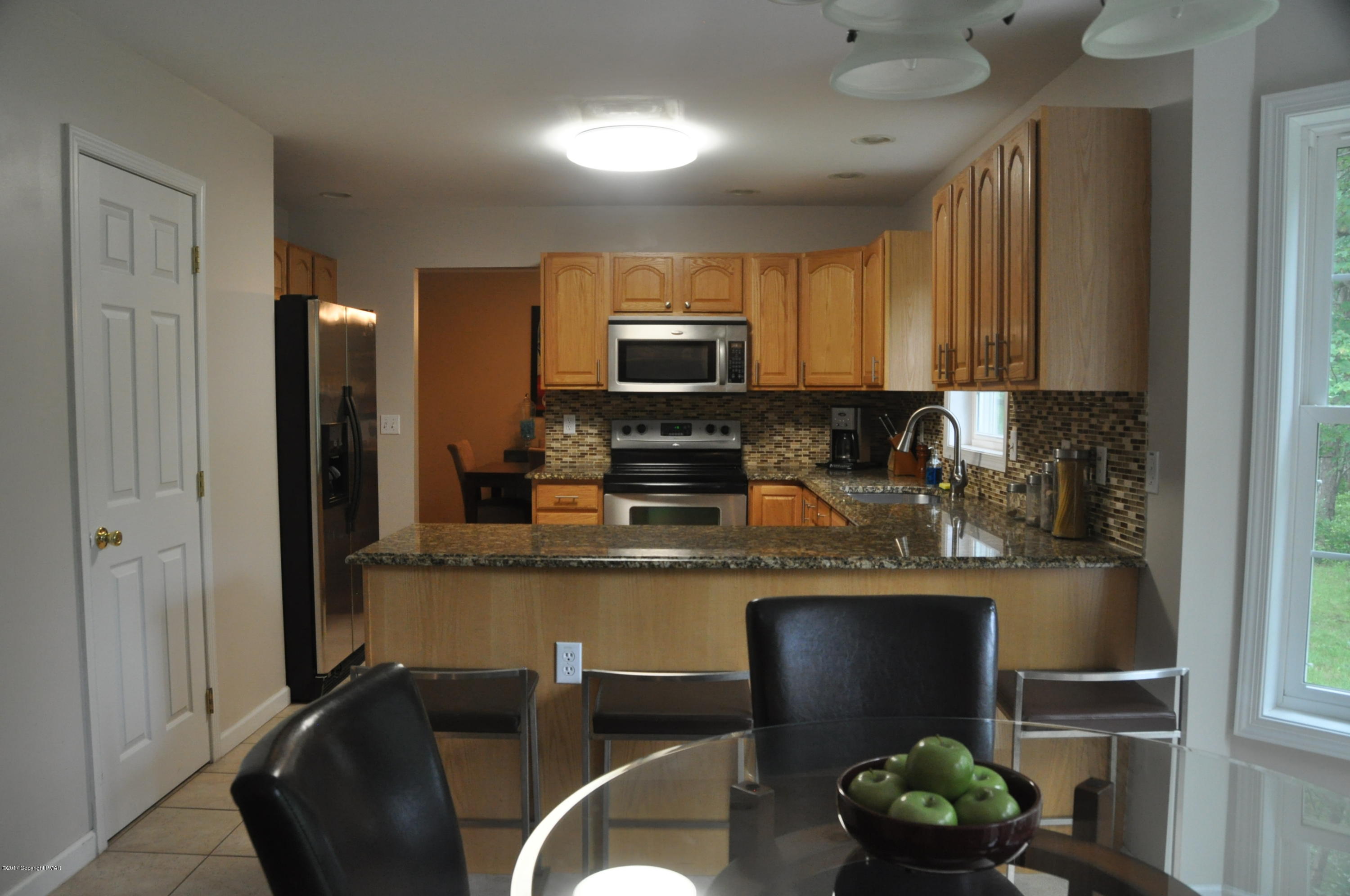 167 Sawmill Road Long Pond, PA 18334 - Photo 10 of 38 a kitchen with stainless steel appliances granite countertop a refrigerator a stove a sink dishwasher and microwave with wooden floor