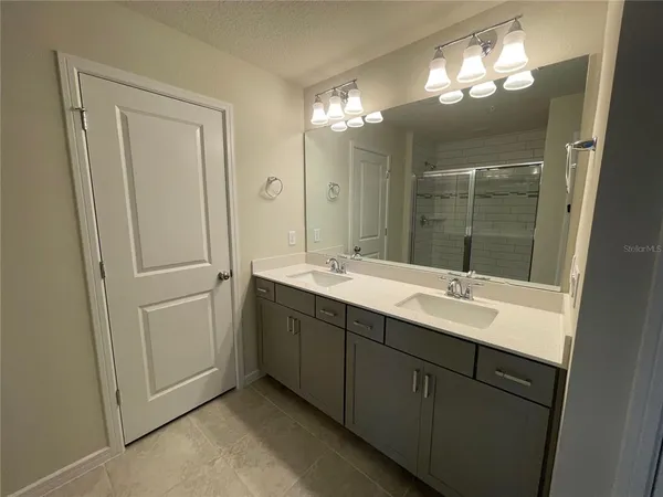 a bathroom with a glass shower door
