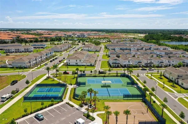 an aerial view of a chairs and table on the patio and a lake view