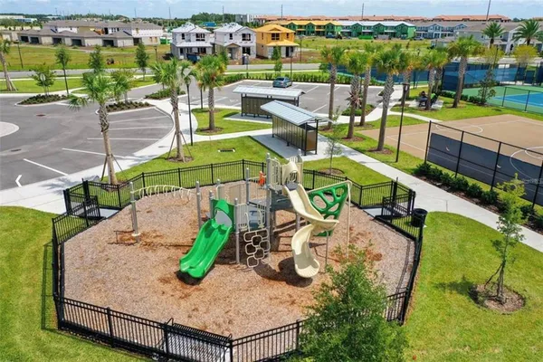 a view of a pool with lawn chairs