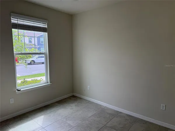 a view of an empty room and a window