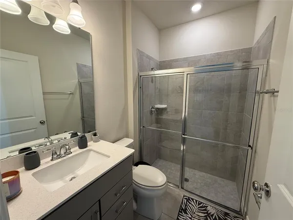 a bathroom with a sink toilet and shower