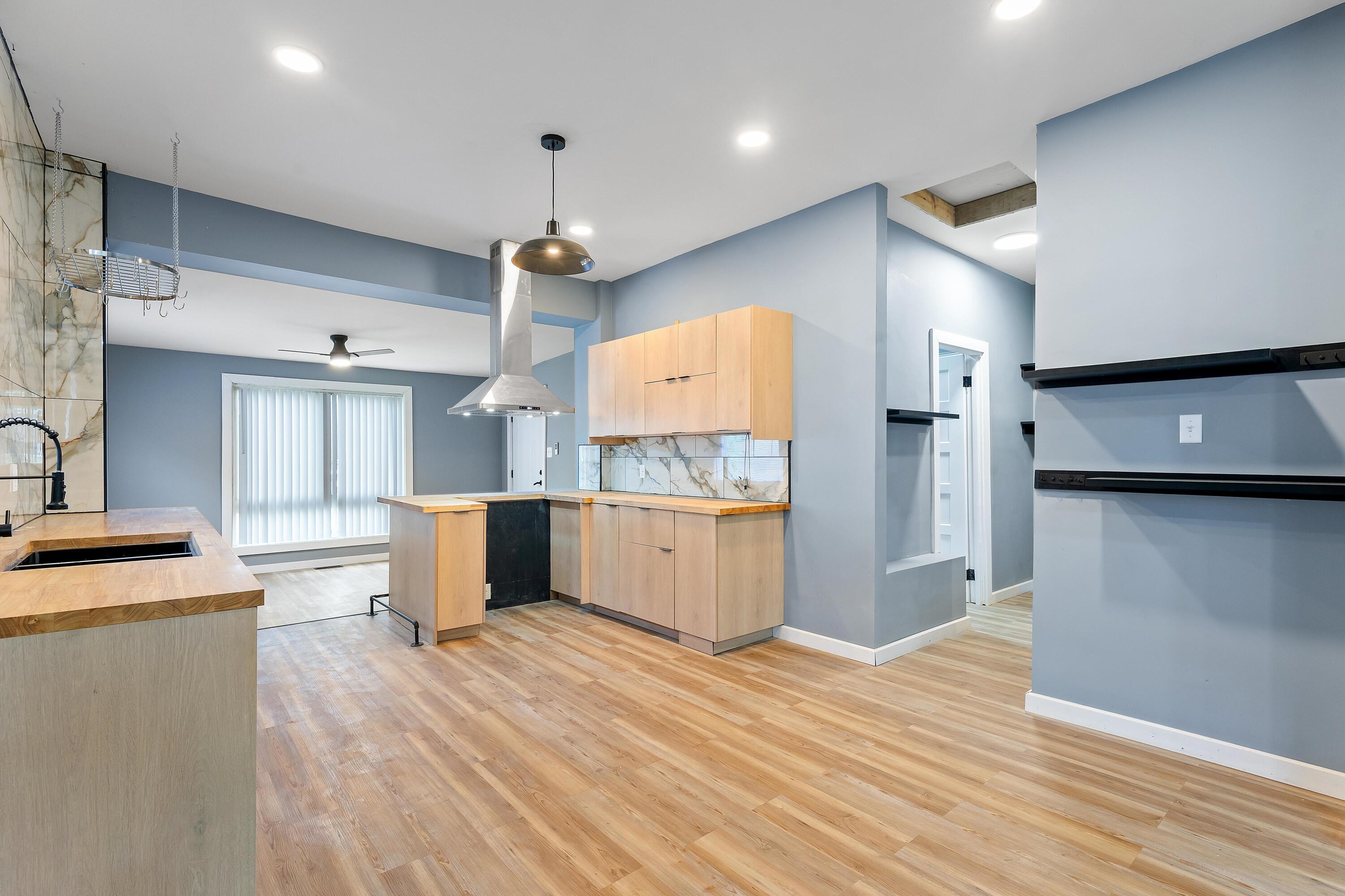 1317 Harrison Street Gary, IN 46407 - Photo 12 of 40 a large kitchen with a lot of counter space and wooden floor