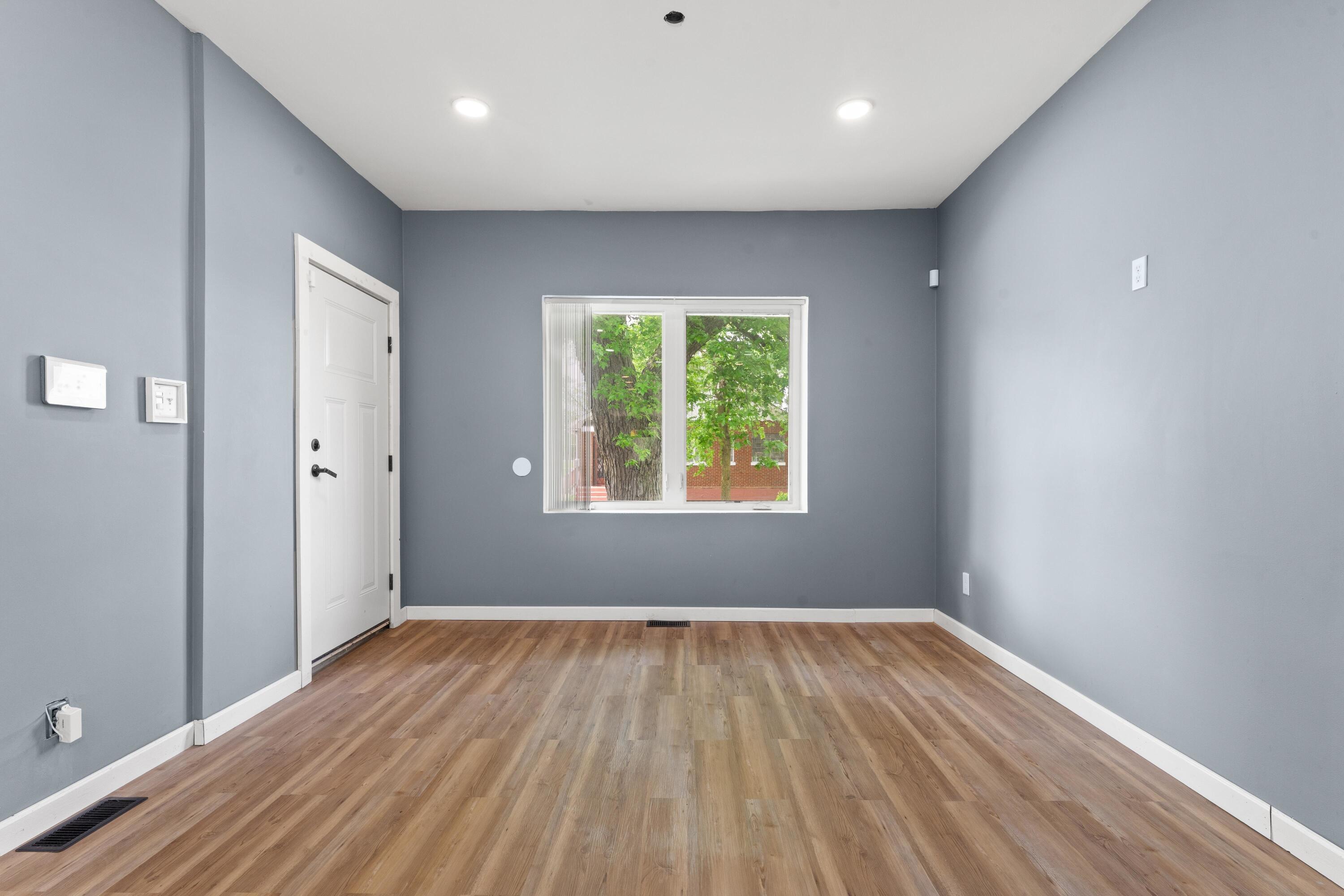 1317 Harrison Street Gary, IN 46407 - Photo 2 of 40 wooden floor in an empty room with a window