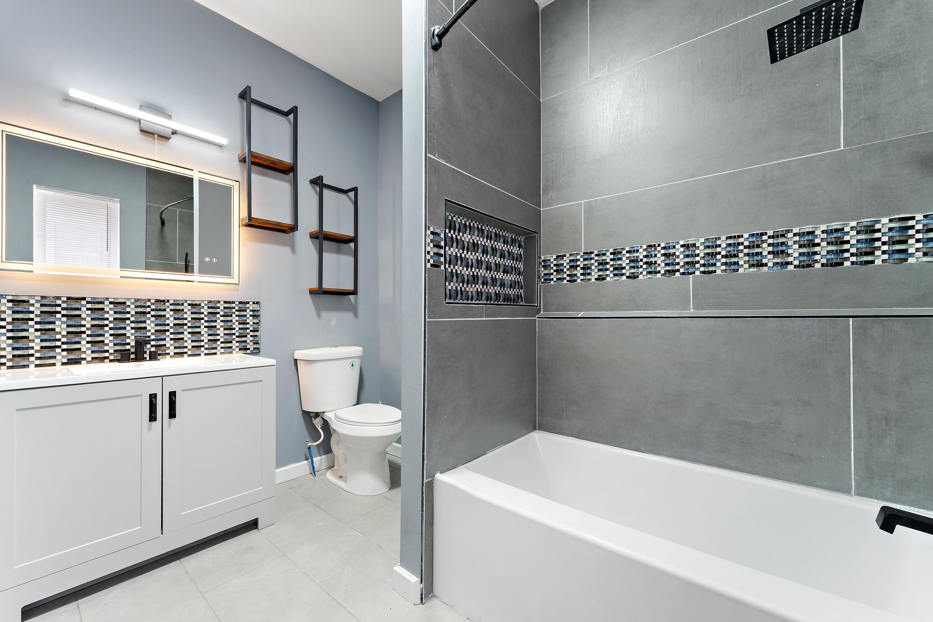 1317 Harrison Street Gary, IN 46407 - Photo 23 of 40 a bathroom with a sink a toilet and shower
