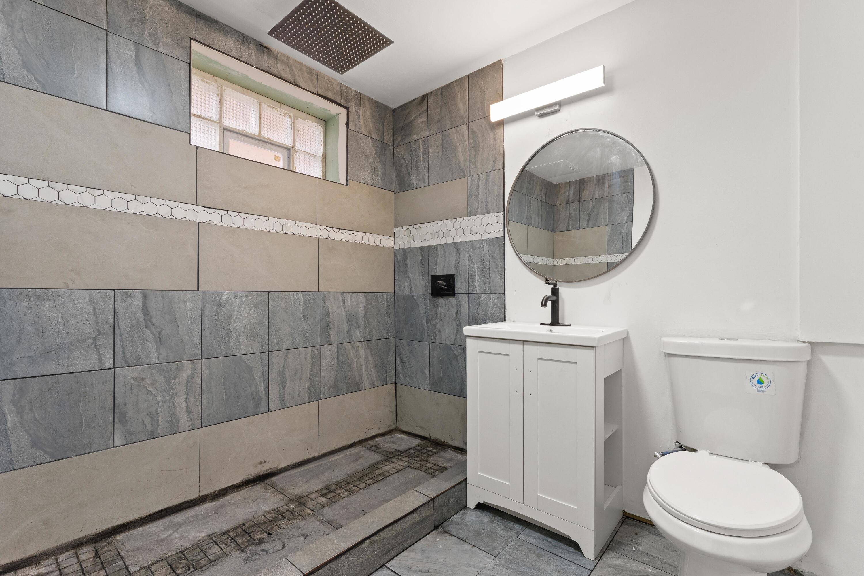 1317 Harrison Street Gary, IN 46407 - Photo 32 of 40 a bathroom with a toilet a sink and a mirror