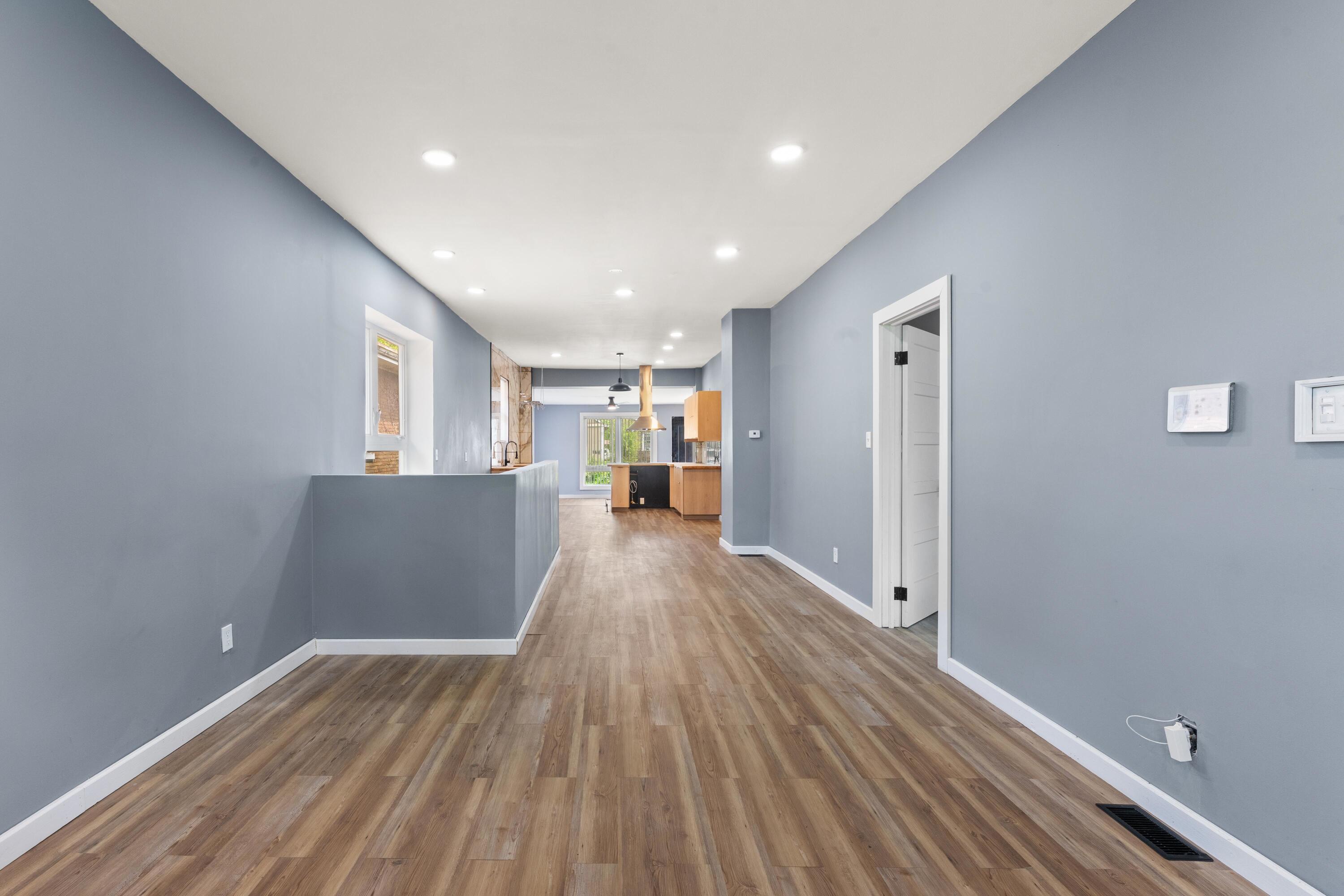 1317 Harrison Street Gary, IN 46407 - Photo 6 of 40 a view of a big room with wooden floor and windows