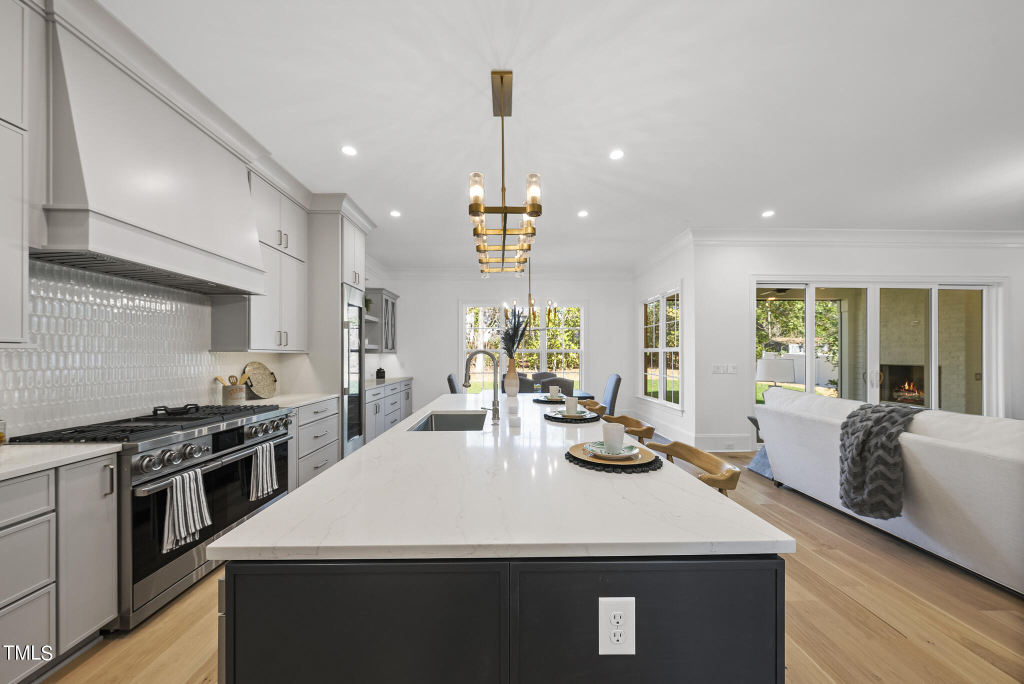 3428 Leonard Street Raleigh, NC 27607 - Photo 13 of 49 a kitchen with stainless steel appliances a sink stove and wooden floor