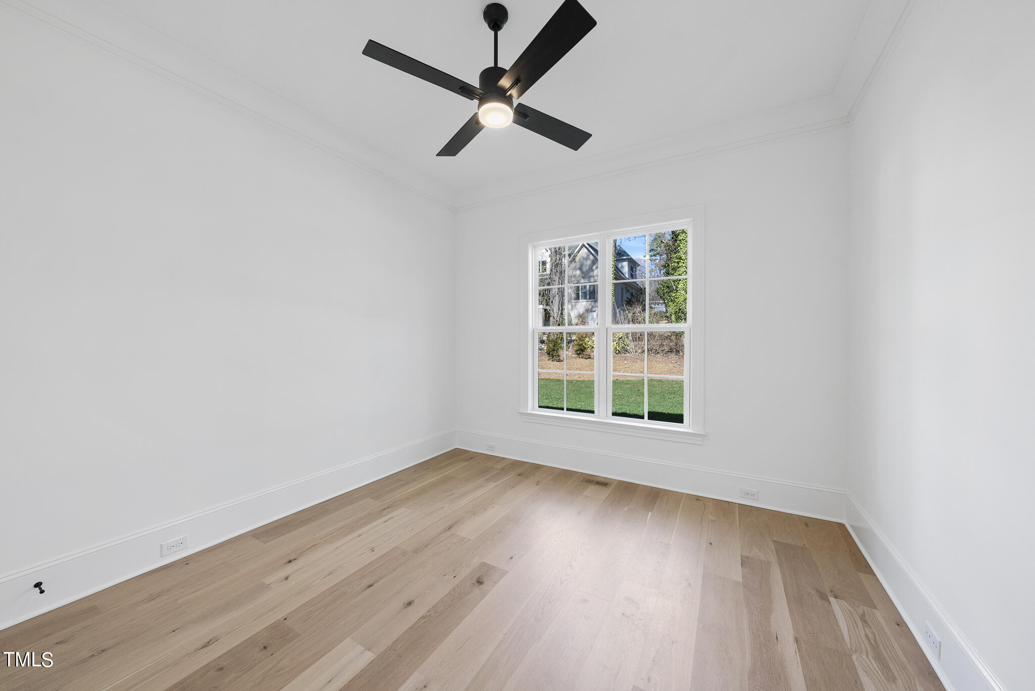 3428 Leonard Street Raleigh, NC 27607 - Photo 21 of 49 an empty room with wooden floor fan and windows