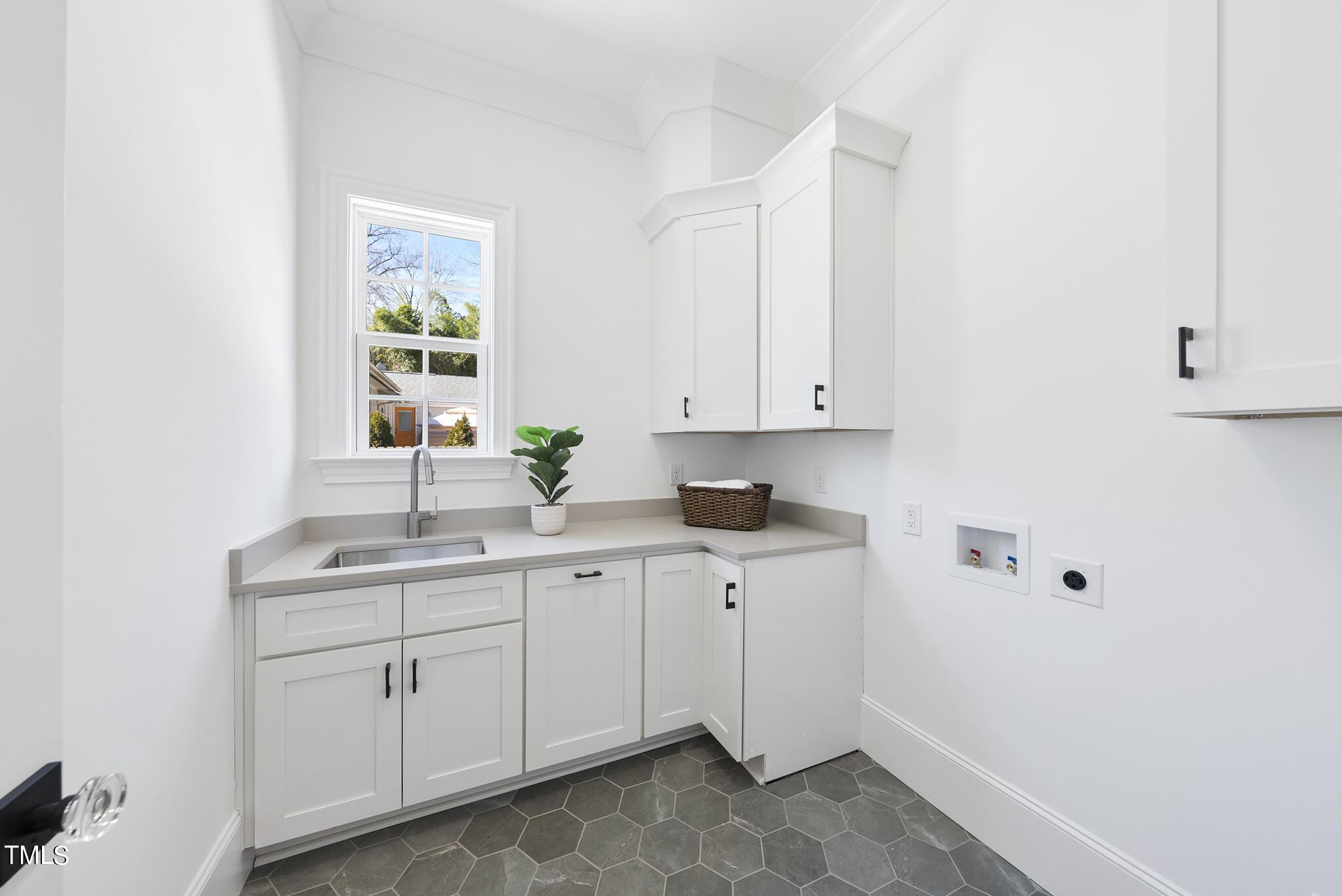 3428 Leonard Street Raleigh, NC 27607 - Photo 43 of 49 a kitchen with a sink cabinets and window