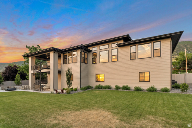 2145 North Main Street Centerville, UT 84014 - Photo 7 of 53 Back of property at dusk with a balcony, a patio area, and outdoor lounge area