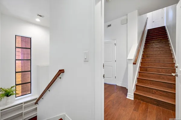 a view of entryway with wooden floor and stairs
