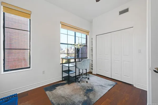 a view of workspace with window and wooden floor