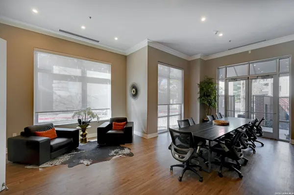a living room with furniture and large windows