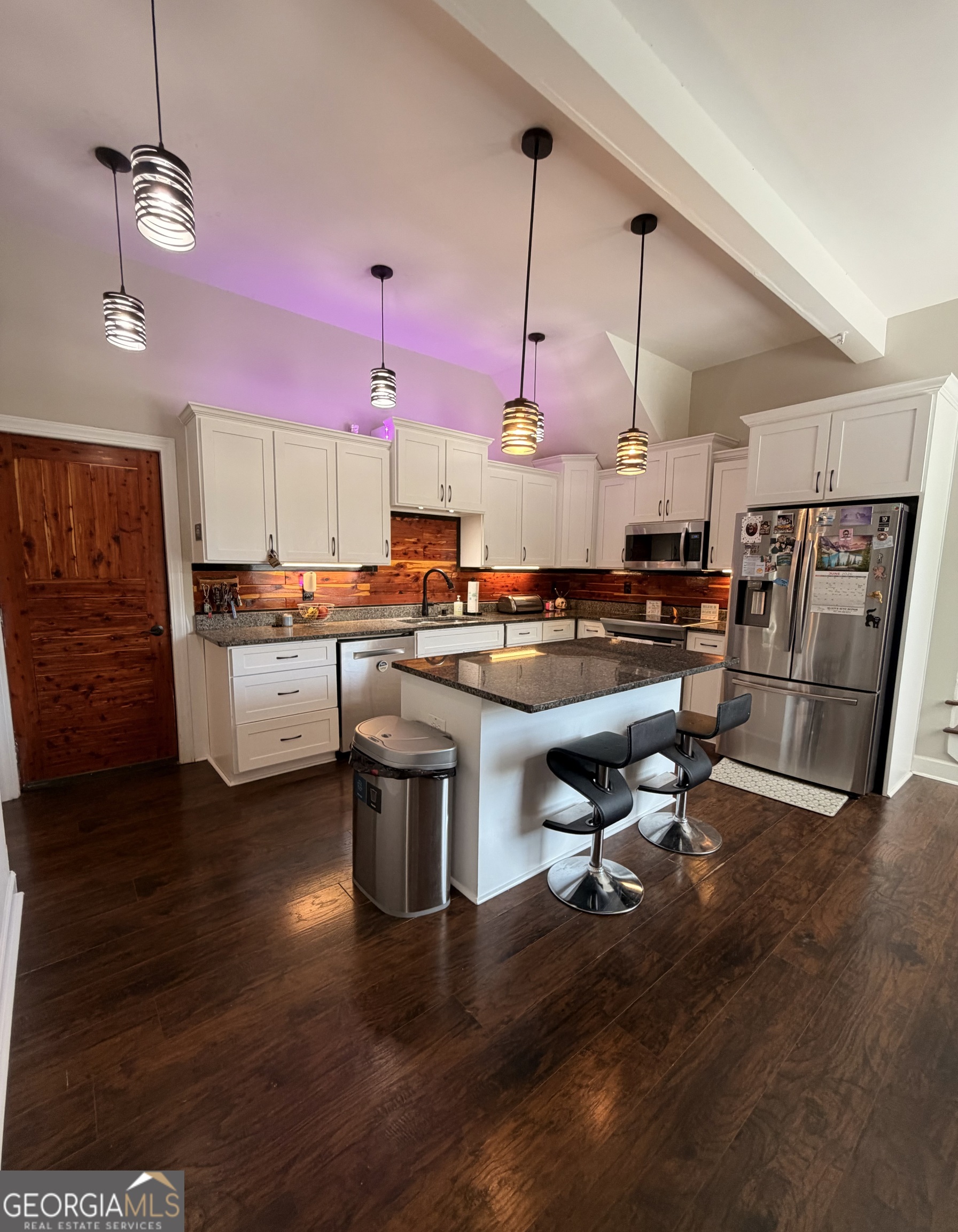 892 Perimeter Road Monticello, GA 31064 - Photo 13 of 38 a room with stainless steel appliances kitchen island granite countertop a stove a sink and a wooden floors