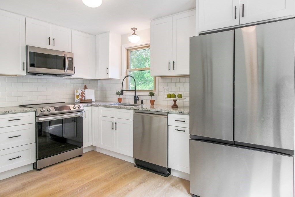 151 Harkness Road, Unit B North Smithfield, RI 02896 - Photo 20 of 36 a kitchen with white cabinets and white appliances