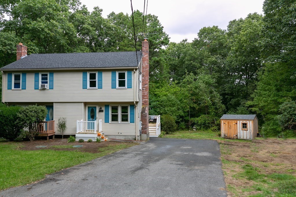 151 Harkness Road, Unit B North Smithfield, RI 02896 - Photo 2 of 36 a front view of a house with a yard and a garage