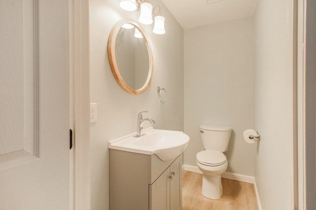 151 Harkness Road, Unit B North Smithfield, RI 02896 - Photo 23 of 36 a white toilet sitting next to a bathroom sink