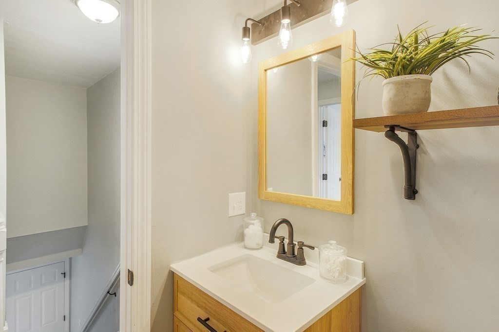 151 Harkness Road, Unit B North Smithfield, RI 02896 - Photo 31 of 36 a bathroom with a sink a mirror and a shower