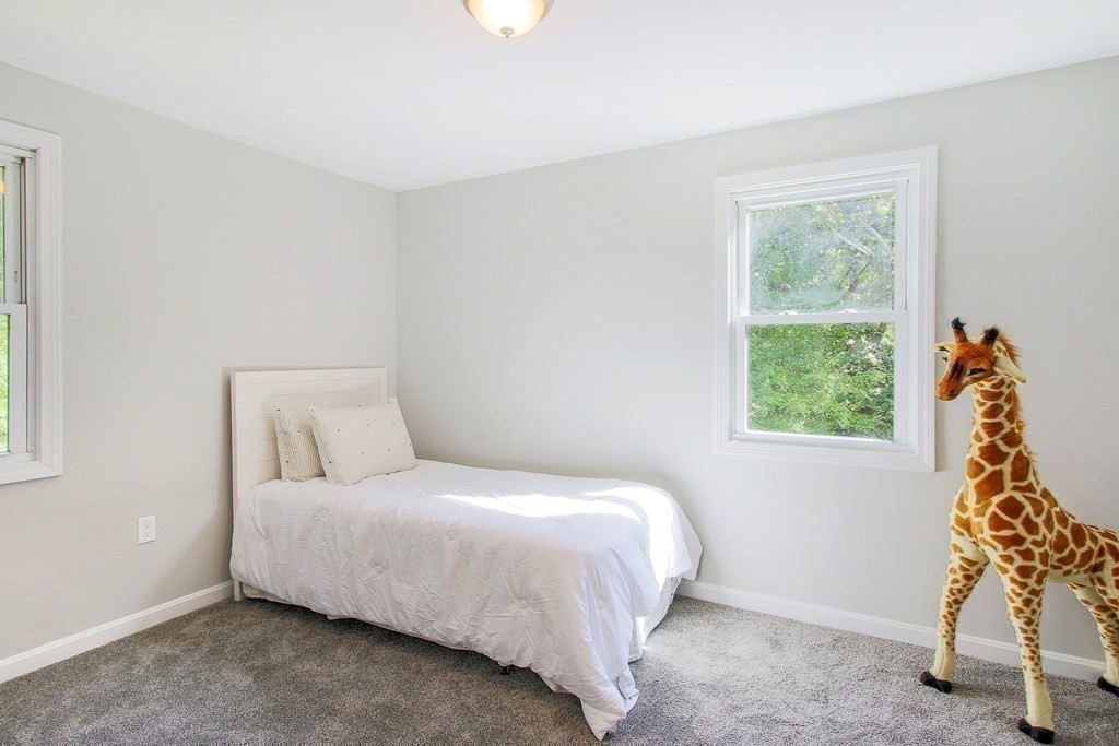 151 Harkness Road, Unit B North Smithfield, RI 02896 - Photo 33 of 36 a bedroom with a bed and a window