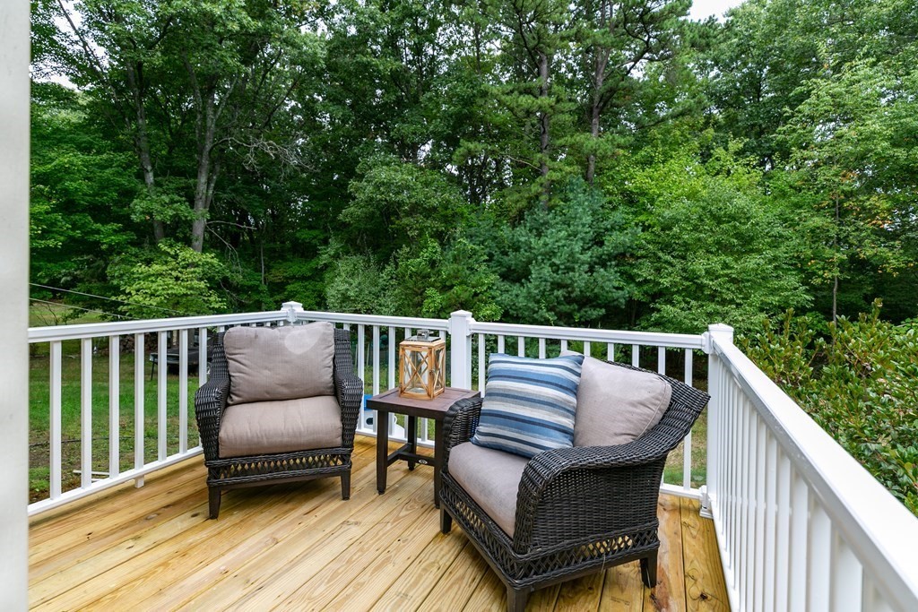 151 Harkness Road, Unit B North Smithfield, RI 02896 - Photo 6 of 36 a view of a wooden deck with furniture