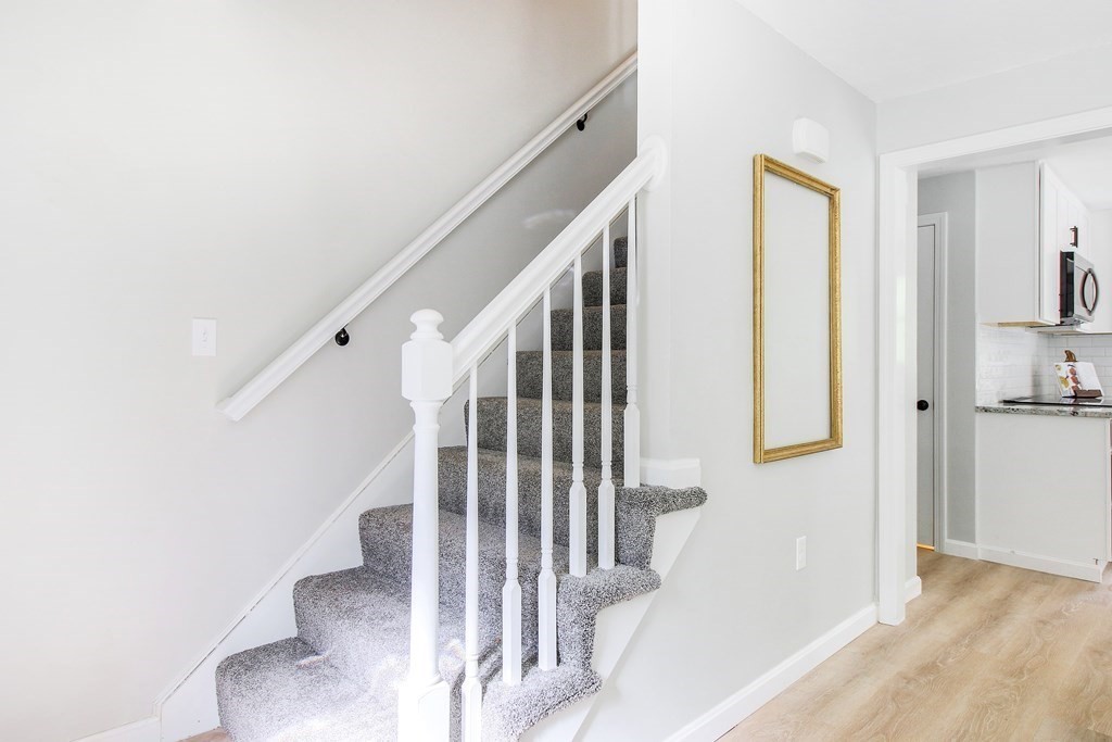151 Harkness Road, Unit B North Smithfield, RI 02896 - Photo 10 of 36 a view of a hallway with staircase