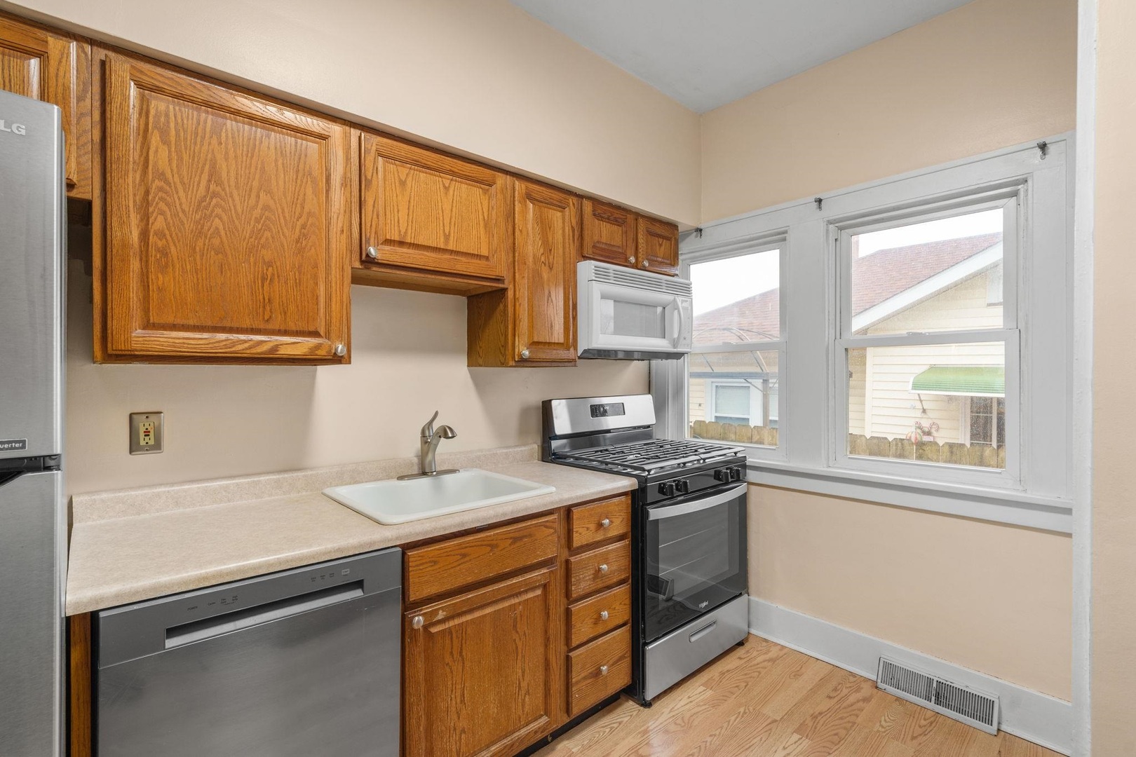 2327 6th Street Moline, IL 61265 - Photo 14 of 22 a kitchen with stainless steel appliances granite countertop a sink stove and cabinets