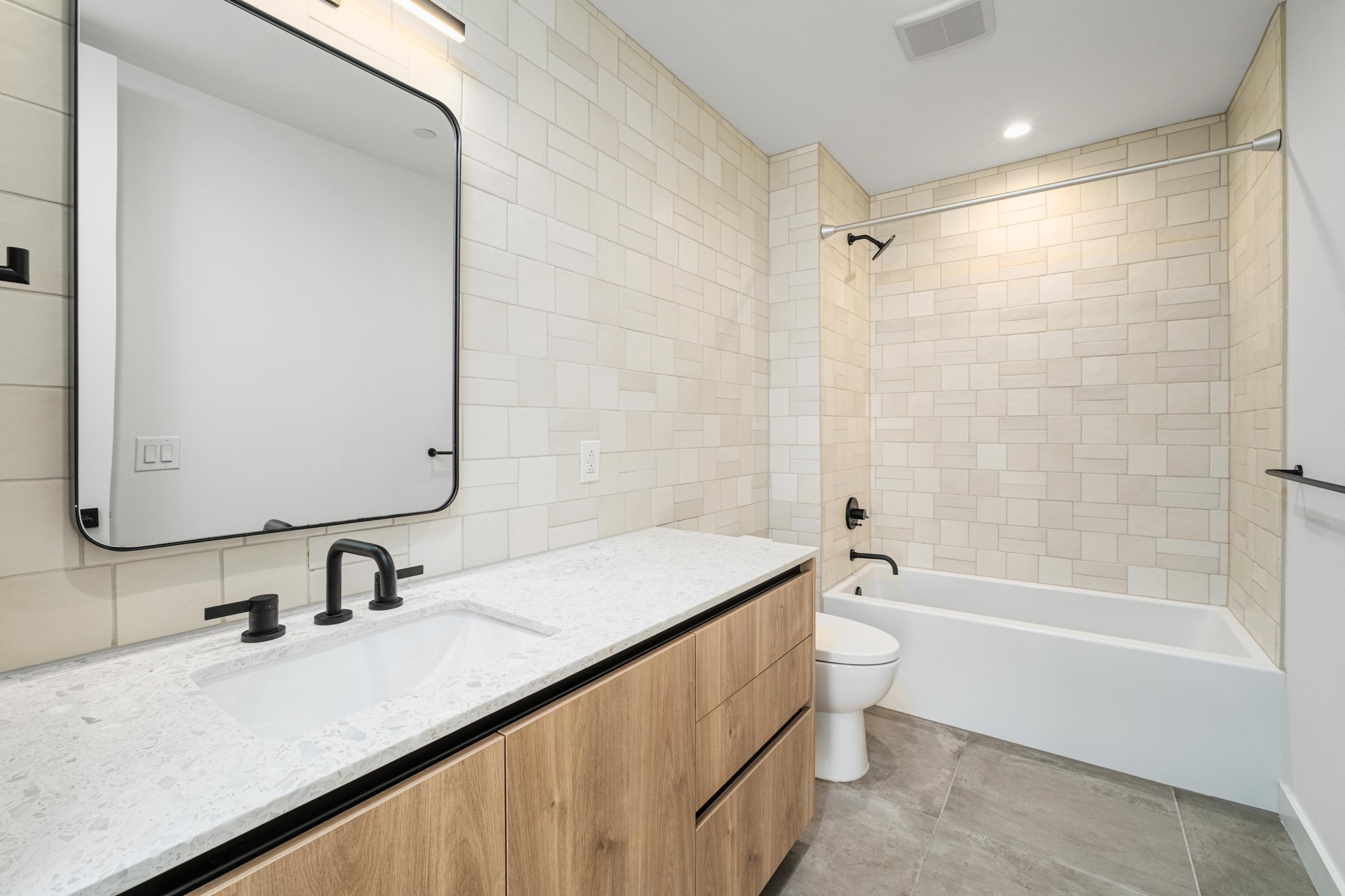 84 East Avenue, Unit 2008 Austin, TX 78701 - Photo 18 of 23 Modern bath with clean lines features a spacious vanity, sleek fixtures, and floor-to-ceiling tiling.
