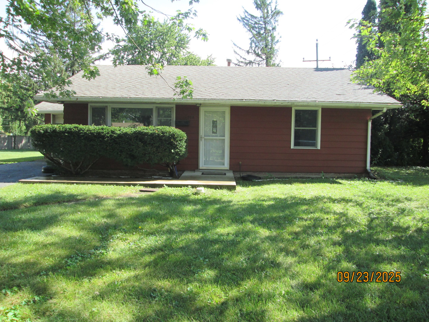 1806 Dallas Place Joliet, IL 60433 - Photo 1 of 13 a view of a yard in front of a house with plants and large tree