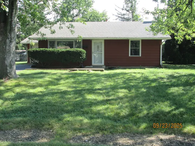 a front view of house with yard and green space