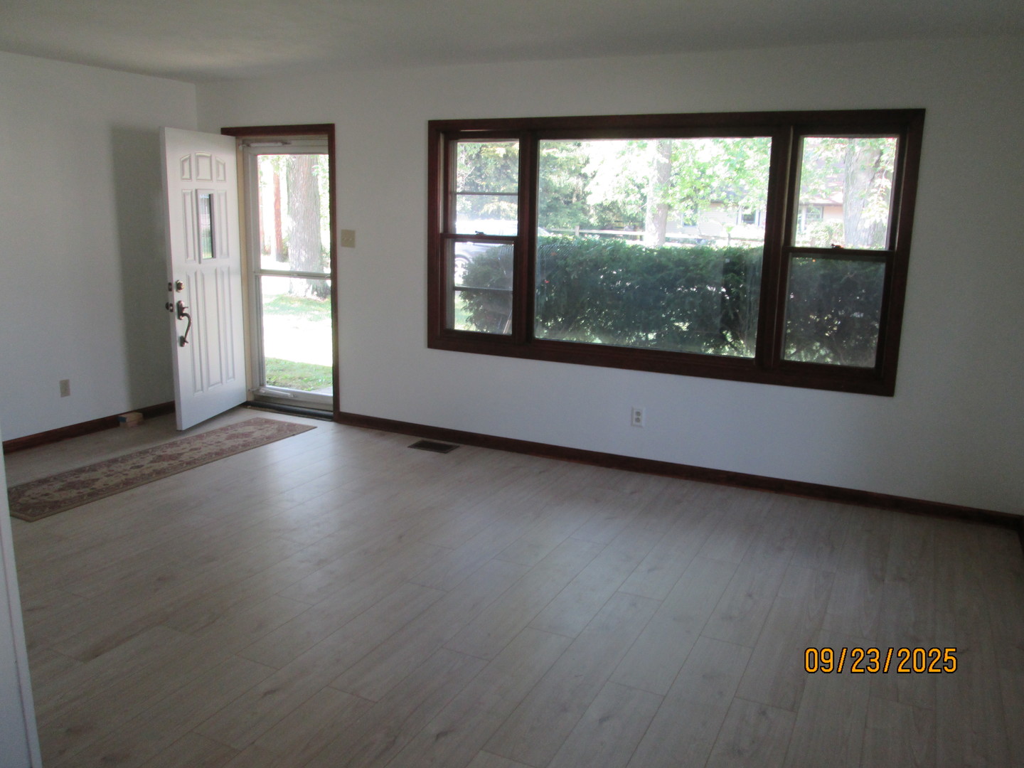 1806 Dallas Place Joliet, IL 60433 - Photo 3 of 13 an empty room with wooden floor and windows
