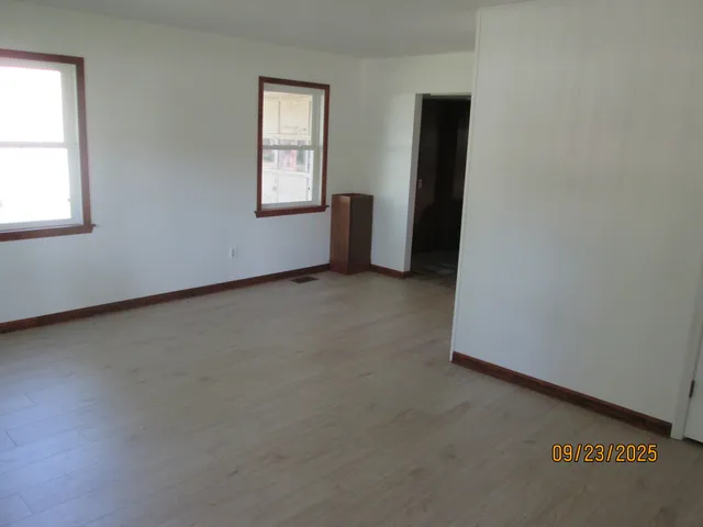 an empty room with windows and closet