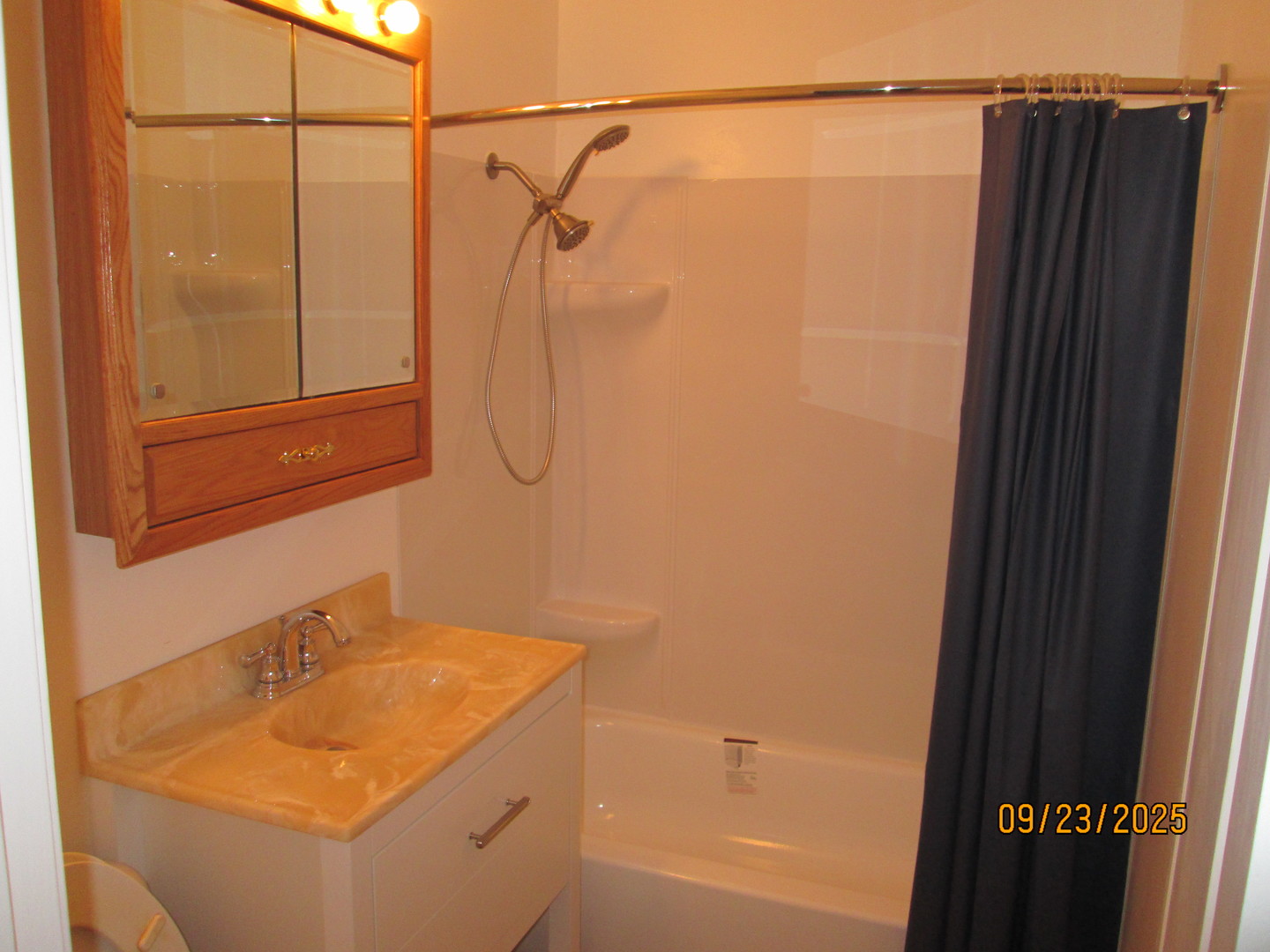 1806 Dallas Place Joliet, IL 60433 - Photo 5 of 13 a bathroom with a shower curtain and a sink