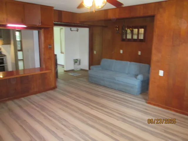 a view of a livingroom with a hardwood floor and a ceiling fan