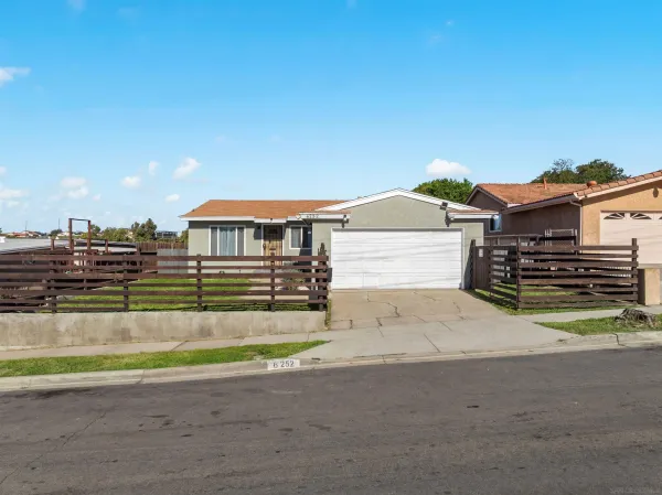 a view of a house with a yard and sitting area