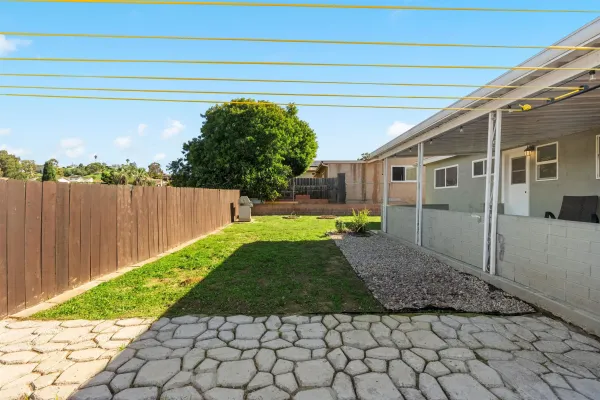 a view of a backyard with plants and a patio
