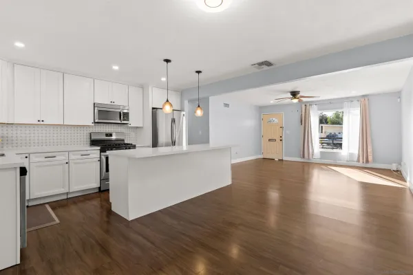 a kitchen with a refrigerator and a stove top oven