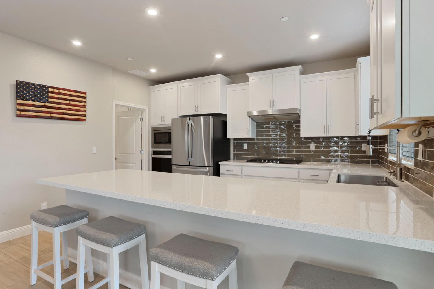 2905 Zinnia Way Lodi, CA 95242 - Photo 13 of 47 a kitchen with stainless steel appliances a refrigerator and a sink