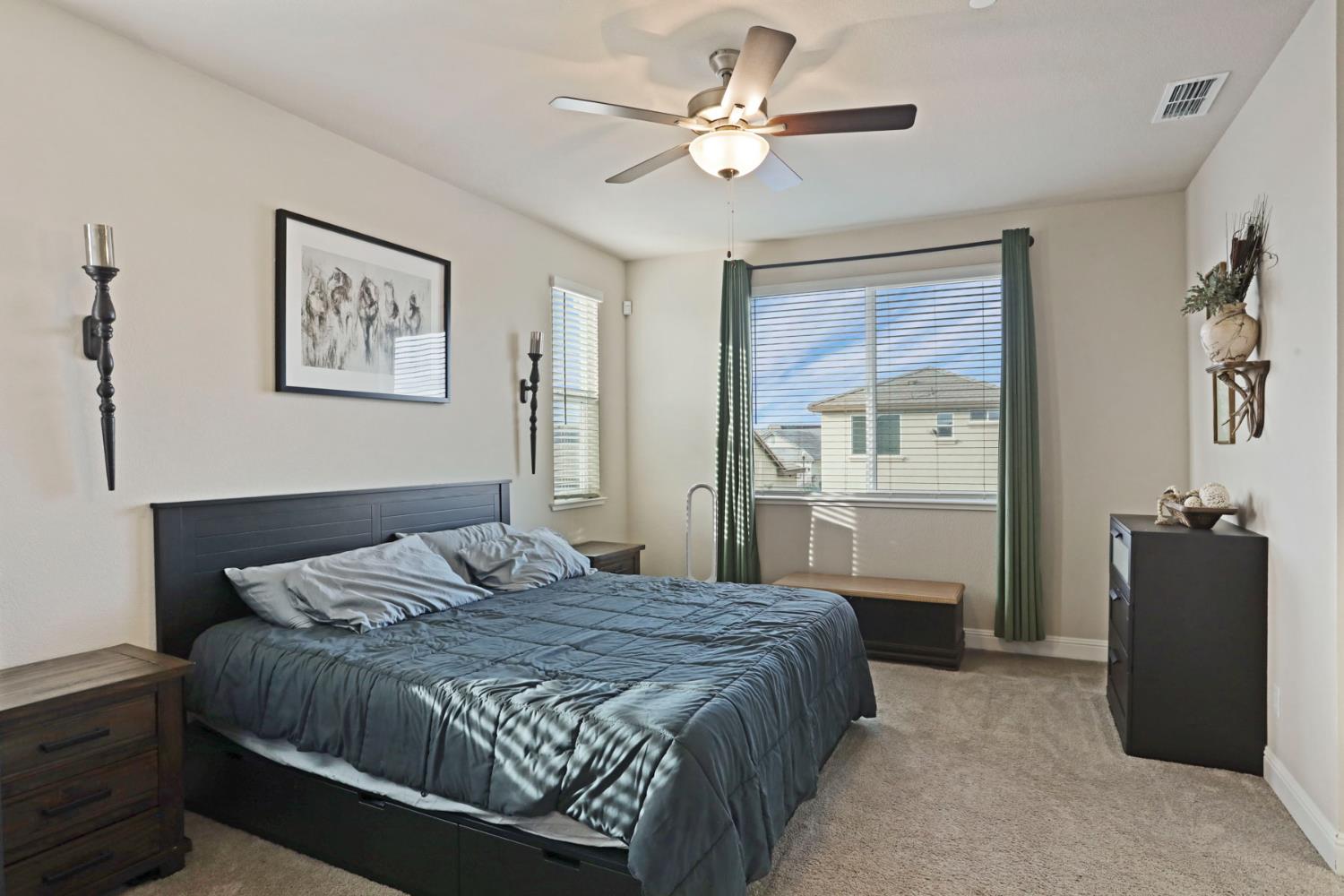 2905 Zinnia Way Lodi, CA 95242 - Photo 29 of 47 a spacious bedroom with a bed and a chandelier
