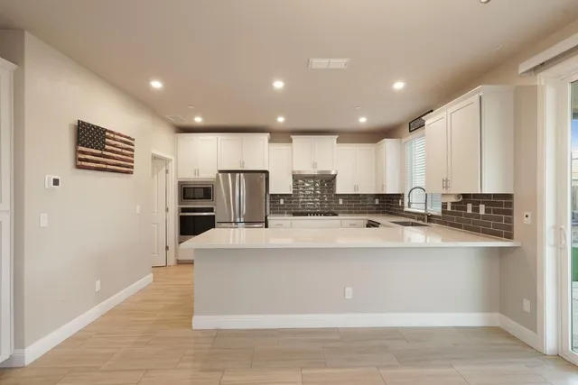 a kitchen with a sink stove and cabinets