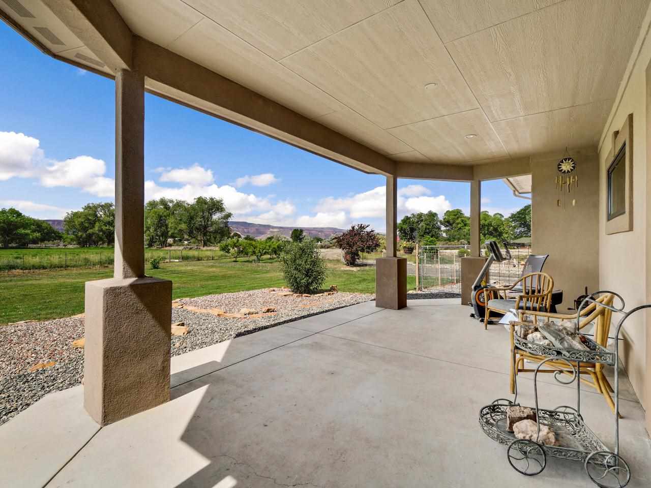 912 23 Road Grand Junction, CO 81505 - Photo 12 of 42 a view of a patio with table and chairs floor to ceiling window