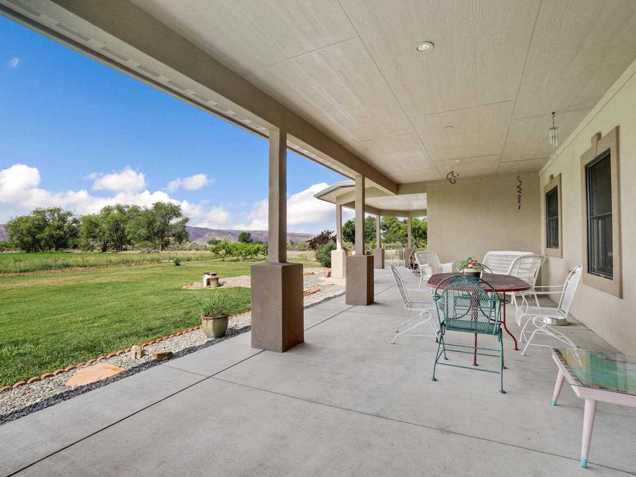 912 23 Road Grand Junction, CO 81505 - Photo 13 of 42 a view of a patio with a table chairs and a backyard