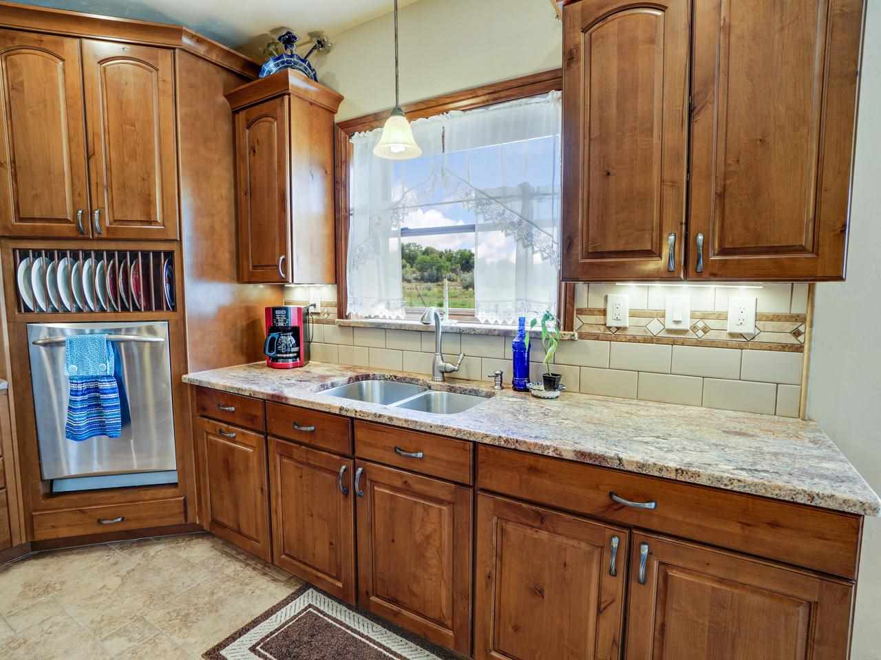 912 23 Road Grand Junction, CO 81505 - Photo 19 of 42 a kitchen with stainless steel appliances granite countertop wooden cabinets a sink and dishwasher