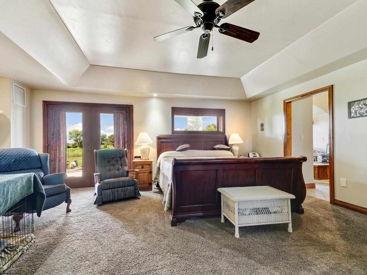912 23 Road Grand Junction, CO 81505 - Photo 26 of 42 a bedroom with a bed and wooden floor