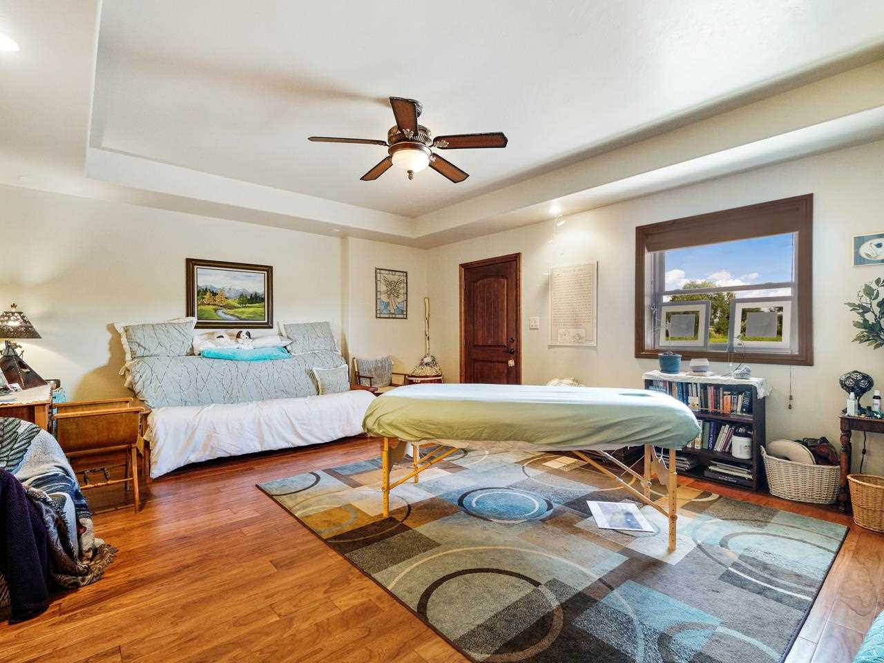 912 23 Road Grand Junction, CO 81505 - Photo 33 of 42 a bedroom with a bed and wooden floor