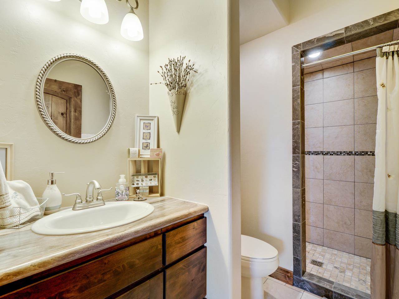912 23 Road Grand Junction, CO 81505 - Photo 35 of 42 a bathroom with a granite countertop toilet a sink and a mirror