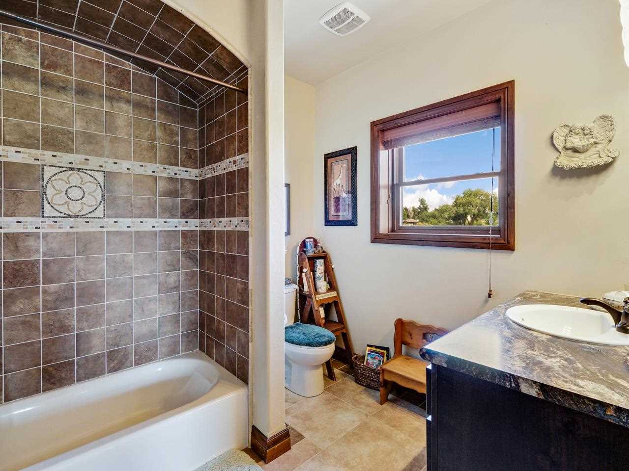 912 23 Road Grand Junction, CO 81505 - Photo 39 of 42 a bathroom with a granite countertop sink mirror toilet and bathtub